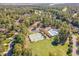 Aerial view showcasing community amenities: pool, tennis courts, recreation field, amidst lush landscaping and trees at 268 The Preserve Trl, Chapel Hill, NC 27517