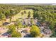 Aerial view of the neighborhood clubhouse, offering golf course access and surrounded by lush greenery and parking at 268 The Preserve Trl, Chapel Hill, NC 27517