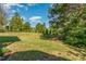 Fenced backyard featuring a meticulously maintained lawn, shrubbery and ample space for recreation or gardening at 268 The Preserve Trl, Chapel Hill, NC 27517