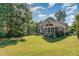 Beautiful backyard with lush green grass, mature trees and a screened-in porch for outdoor living at 268 The Preserve Trl, Chapel Hill, NC 27517