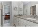 Bathroom vanity featuring double sinks, granite countertops, and access to an adjacent bedroom at 268 The Preserve Trl, Chapel Hill, NC 27517
