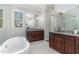 Primary bathroom features a soaking tub, double vanity sinks, and large mirrors at 268 The Preserve Trl, Chapel Hill, NC 27517