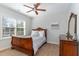 Cozy bedroom with natural light features a decorative wood-framed sleigh bed and serene ambiance at 268 The Preserve Trl, Chapel Hill, NC 27517