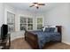 Bedroom with large windows, wood-framed bed, and neutral decor featuring natural light at 268 The Preserve Trl, Chapel Hill, NC 27517