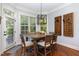 Dining room with wood table, modern light fixture, and view of backyard at 268 The Preserve Trl, Chapel Hill, NC 27517
