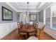 Formal dining room features wainscoting, hardwood floors, tray ceiling, and seating for eight at 268 The Preserve Trl, Chapel Hill, NC 27517