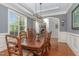 Dining room features tray ceiling, hardwood floors, and an arched doorway leading to an office at 268 The Preserve Trl, Chapel Hill, NC 27517