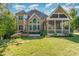 Backyard view with a patio, landscaped garden, and an attached screened-in porch, a great outdoor space at 268 The Preserve Trl, Chapel Hill, NC 27517