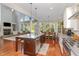 Open-concept kitchen with granite countertops, stainless steel appliances, and hardwood floors at 268 The Preserve Trl, Chapel Hill, NC 27517