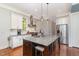 Bright kitchen with white cabinets, granite countertops, stainless steel appliances and large kitchen island at 268 The Preserve Trl, Chapel Hill, NC 27517