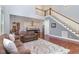 Open-concept living area with a staircase, high ceilings, and views into the modern kitchen at 268 The Preserve Trl, Chapel Hill, NC 27517