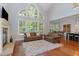 Spacious living room with high ceilings, hardwood floors, a stone fireplace, and large windows at 268 The Preserve Trl, Chapel Hill, NC 27517