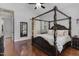 Primary bedroom featuring a four-poster bed, hardwood floors, and a ceiling fan at 268 The Preserve Trl, Chapel Hill, NC 27517