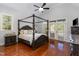 Spacious primary bedroom with a four-poster bed, vaulted ceiling, and French doors to the exterior at 268 The Preserve Trl, Chapel Hill, NC 27517