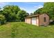 View of the detached garage with basketball hoop in the backyard at 2704 Atlantic St, Durham, NC 27707