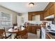 Functional kitchen with wooden cabinets, standard appliances, and an adjacent dining area at 2704 Atlantic St, Durham, NC 27707