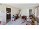 Cozy living room with neutral tones, leading into the kitchen and other rooms in the home at 2704 Atlantic St, Durham, NC 27707