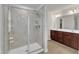 Bathroom with glass shower to the left and double sink brown vanity to the right at 3413 Fairstone Rd, Wake Forest, NC 27587