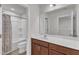 Bathroom features a white sink, brown vanity, large mirror, toilet and shower with tub insert at 3413 Fairstone Rd, Wake Forest, NC 27587