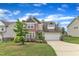 Charming two-story home featuring a spacious driveway and manicured front yard at 3413 Fairstone Rd, Wake Forest, NC 27587
