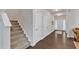 Bright foyer with staircase, neutral walls, hardwood floors, and white doors leading to other rooms in the home at 3413 Fairstone Rd, Wake Forest, NC 27587