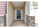 Inviting front porch with stone accents and a stylish black front door at 3413 Fairstone Rd, Wake Forest, NC 27587
