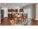 A well-appointed dining area with brown cabinets, stainless steel appliances, and lots of light at 3413 Fairstone Rd, Wake Forest, NC 27587