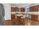 A stunning kitchen with brown cabinets, a center island, and stainless steel appliances at 3413 Fairstone Rd, Wake Forest, NC 27587