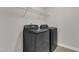 Functional laundry room features a modern washer and dryer set with shelving for storage and white trim at 3413 Fairstone Rd, Wake Forest, NC 27587