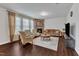 Comfortable living room features a stone fireplace, sofa, chairs, and large windows at 3413 Fairstone Rd, Wake Forest, NC 27587