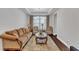 Comfortable living room with elegant furnishings, large windows, and hardwood flooring at 3413 Fairstone Rd, Wake Forest, NC 27587