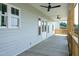 Spacious covered back porch featuring ceiling fans, offering a comfortable outdoor living space with a backyard view at 3417 Aspen Rd, Rocky Mount, NC 27804