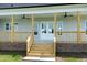 Charming covered back porch with ceiling fans, natural wood columns, and a brick foundation, perfect for relaxing at 3417 Aspen Rd, Rocky Mount, NC 27804