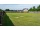 Large, grassy backyard with a wooden privacy fence, offering ample space for recreation and landscaping opportunities at 3417 Aspen Rd, Rocky Mount, NC 27804