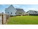 Expansive backyard featuring a covered porch, pristine lawn, and a privacy fence, perfect for outdoor activities at 3417 Aspen Rd, Rocky Mount, NC 27804