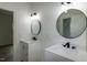 Modern bathroom features a double vanity with circular mirrors and stylish lighting at 3417 Aspen Rd, Rocky Mount, NC 27804