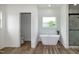 Luxurious bathroom with freestanding tub, glass shower, and elegant fixtures at 3417 Aspen Rd, Rocky Mount, NC 27804