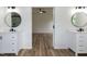 New bathroom boasts a double sink vanity with sleek fixtures, complemented by wood flooring at 3417 Aspen Rd, Rocky Mount, NC 27804