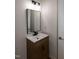 Modern bathroom vanity featuring a sink, mirror, cabinet and light fixtures at 3417 Aspen Rd, Rocky Mount, NC 27804
