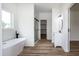 Bright bathroom features a modern soaking tub, dual vanity, and walk-in closet access at 3417 Aspen Rd, Rocky Mount, NC 27804