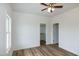 Cozy bedroom featuring wood-look floors, a ceiling fan, and ample natural light at 3417 Aspen Rd, Rocky Mount, NC 27804