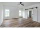 Bright bedroom with hardwood floors, dual windows, and sliding barn door to bathroom at 3417 Aspen Rd, Rocky Mount, NC 27804