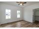 Bright bedroom with a ceiling fan, wood-look floors and closet at 3417 Aspen Rd, Rocky Mount, NC 27804