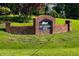 Charming brick sign marking the entrance to Old Carriage Farm, surrounded by lush greenery at 3417 Aspen Rd, Rocky Mount, NC 27804