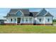 Inviting home features a covered front porch and well-manicured lawn, providing great curb appeal at 3417 Aspen Rd, Rocky Mount, NC 27804