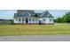 Beautifully landscaped home with a covered front porch and lush lawn, situated on a desirable lot at 3417 Aspen Rd, Rocky Mount, NC 27804