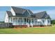 Stunning home with a covered front porch, brick accents, and well-kept lawn, creating a welcoming entrance at 3417 Aspen Rd, Rocky Mount, NC 27804