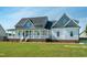 Attractive home with a covered front porch, manicured lawn, and tasteful landscaping, showcasing curb appeal at 3417 Aspen Rd, Rocky Mount, NC 27804