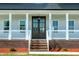 Charming covered front porch with a view of the beautiful lawn and landscaping at 3417 Aspen Rd, Rocky Mount, NC 27804