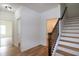 Hallway with hardwood floors, staircase with wood and iron, and bright white walls at 3417 Aspen Rd, Rocky Mount, NC 27804